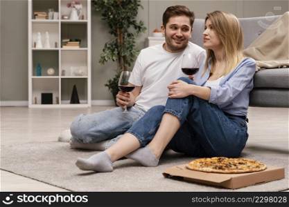 couple watching tv drinking wine