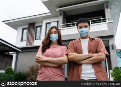 couple wearing face mask for protect coronavirus (covid-19) at their home