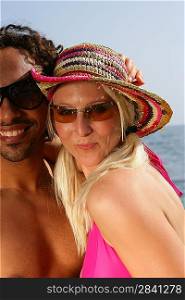 Couple wearing sunglasses at the beach