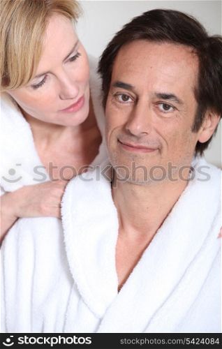 Couple wearing white bathrobes