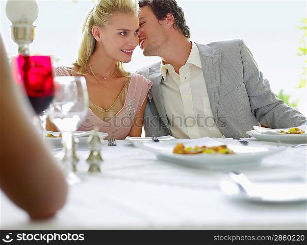 Couple Whispering at Dinner