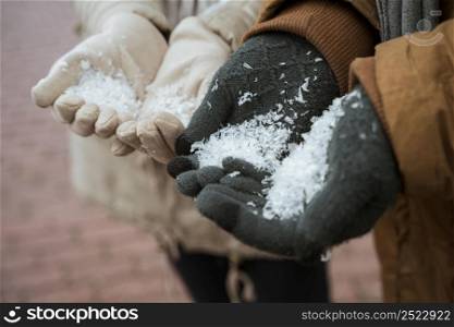 couple winter holding snow their hands