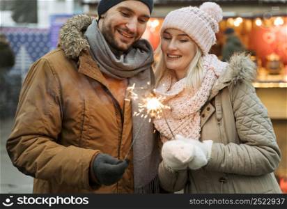 couple winter woman holding firework sparkle