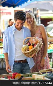 Couple with a basket at market