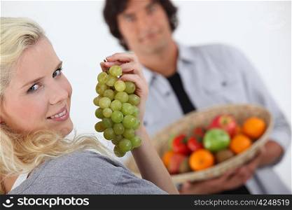 Couple with a basket of fruit