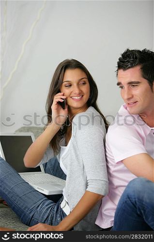 Couple with a cellphone on a sofa