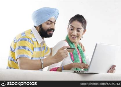 Couple with a laptop and credit card