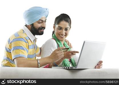 Couple with a laptop and credit card