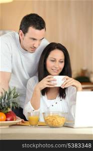 Couple with a laptop in the kitchen