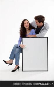 Couple with a picture frame left blank for your image