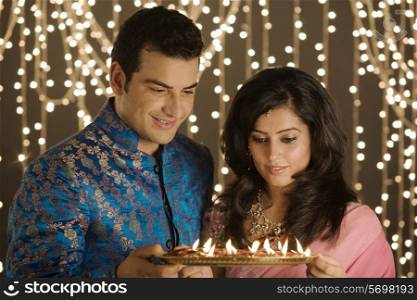 Couple with a tray of diyas