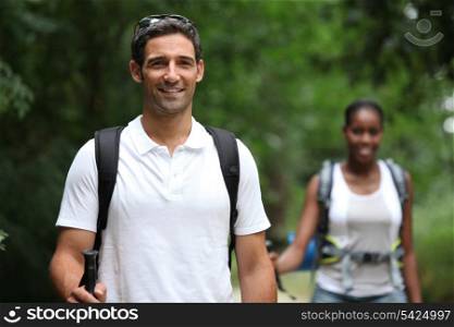 Couple with backpacks in the forest