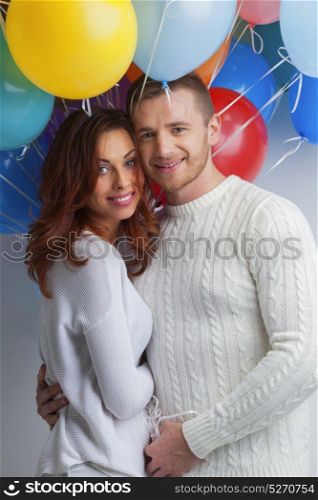 Couple with balloons. Young smiling hugging couple with balloons