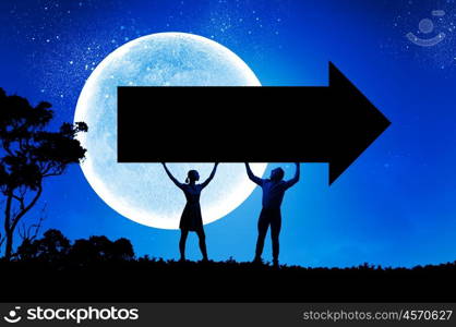 Couple with banner. Silhouettes of young couple holding black arrow banner