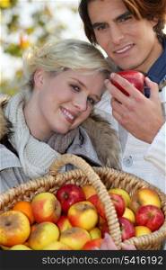 Couple with basket of apples