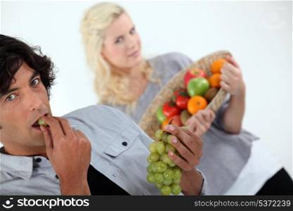 couple with basket of fruit