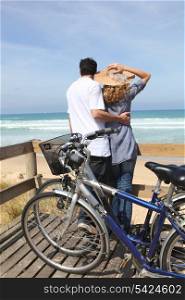 Couple with bikes by the sea