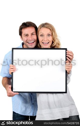 couple with blank picture frame