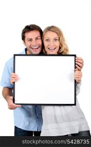 couple with blank picture frame