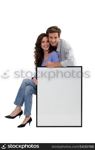 Couple with blank picture frame