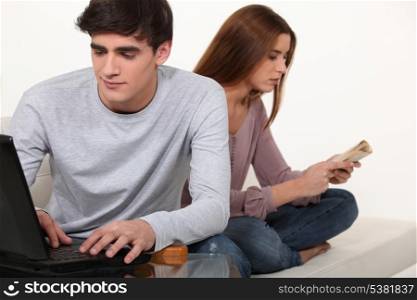 Couple with book and laptop
