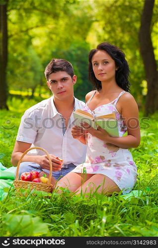 couple with book looking at camera