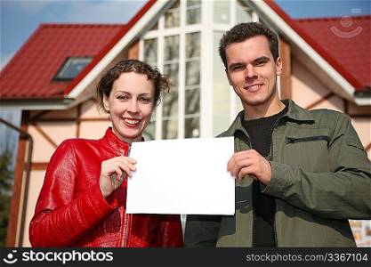 couple with card and house
