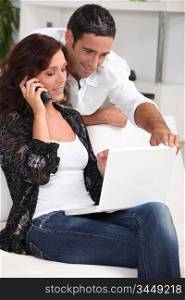 Couple with computer and phone