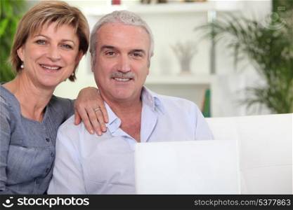 Couple with computer on couch