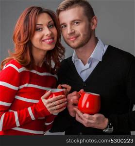 Couple with cups. Happy couple in love holding red cups, Valentines day concept