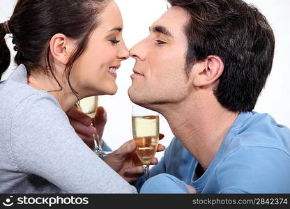 couple with flute of champagne canoodling