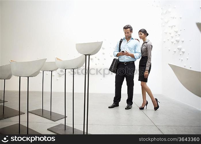 Couple with Glazed ceramics boats in art gallery
