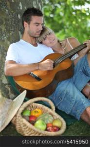 Couple with guitar in the field