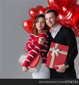 Couple with heart shaped balloons and gifts, Valentines day
