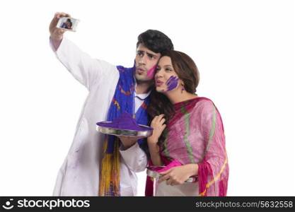 Couple with holi colours taking a self portrait