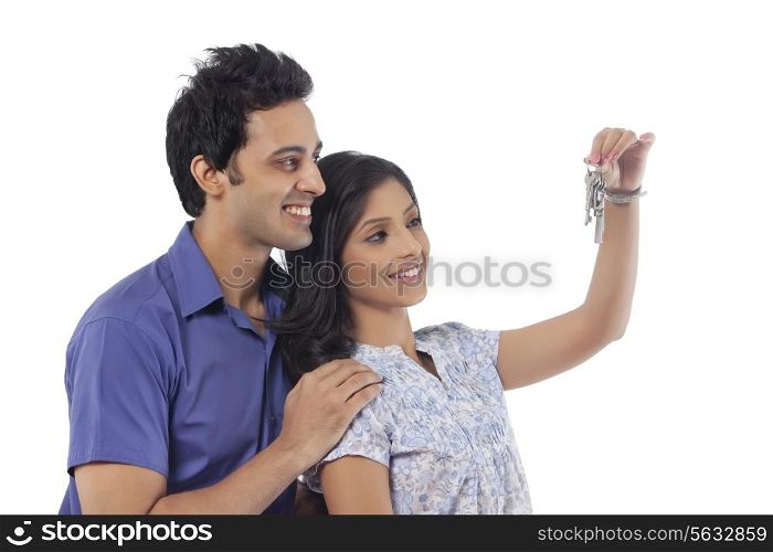 Couple with keys smiling