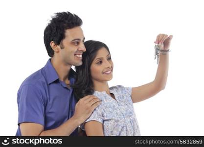 Couple with keys smiling