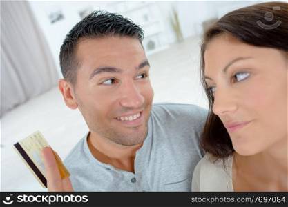 couple with laptop and credit card at home