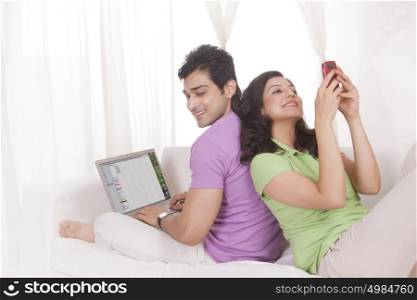 Couple with laptop and mobile phone