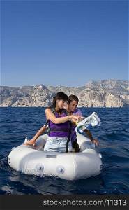 Couple with map on dingy boat