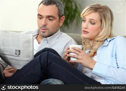 Couple with newspaper