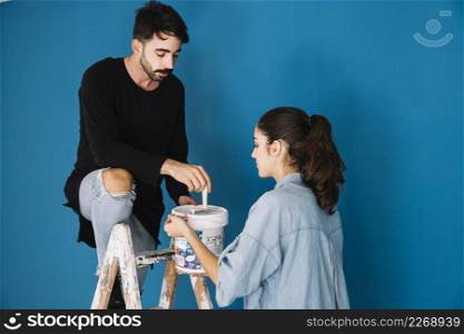 couple with paint ladder