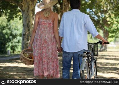 Couple with picnic basket and bike