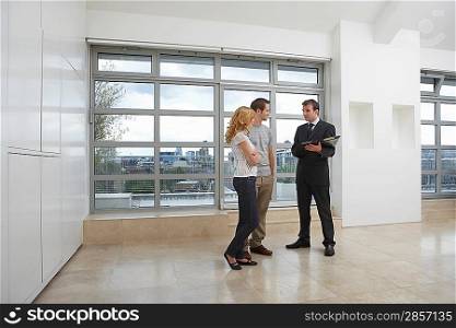 Couple With Real Estate Agent in Apartment