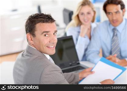 Couple with real-estate agent in office