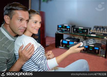 Couple with remote control for sound system