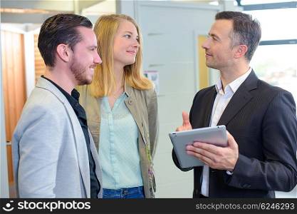 Couple with salesman holding tablet