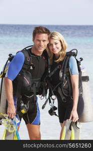 Couple With Scuba Diving Equipment Enjoying Beach Holiday