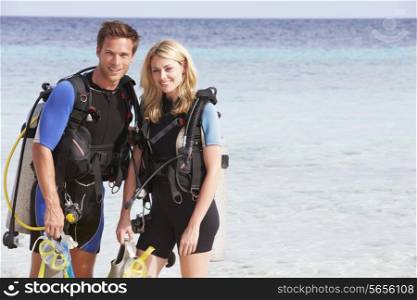 Couple With Scuba Diving Equipment Enjoying Beach Holiday