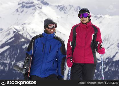 Couple with ski poles on mountain